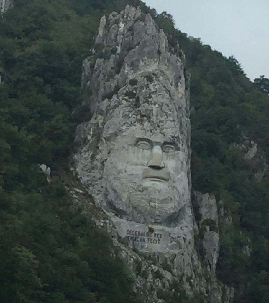 stone face carved into a rock outcropping on the Danube River
