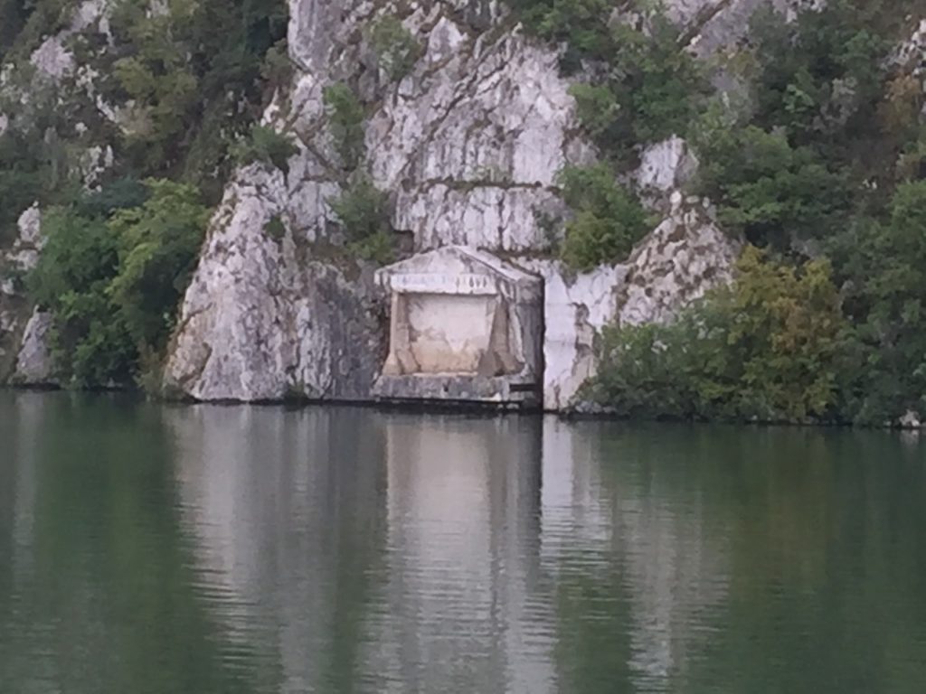 Square Roman monument carved into the rock only a foot above the water of the Danube