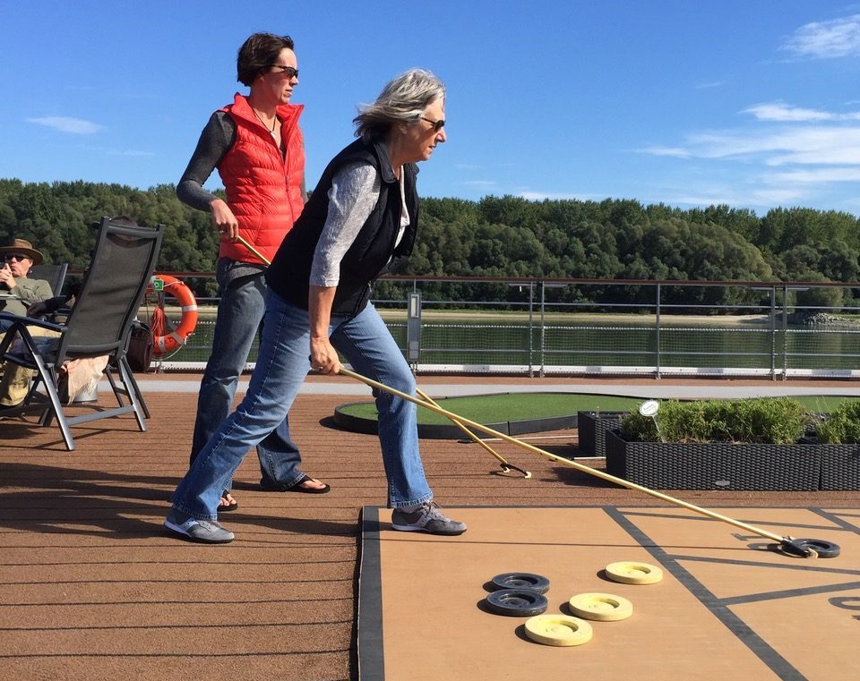 two women playing shuffleboard on the deck of the Viking ship Aegir