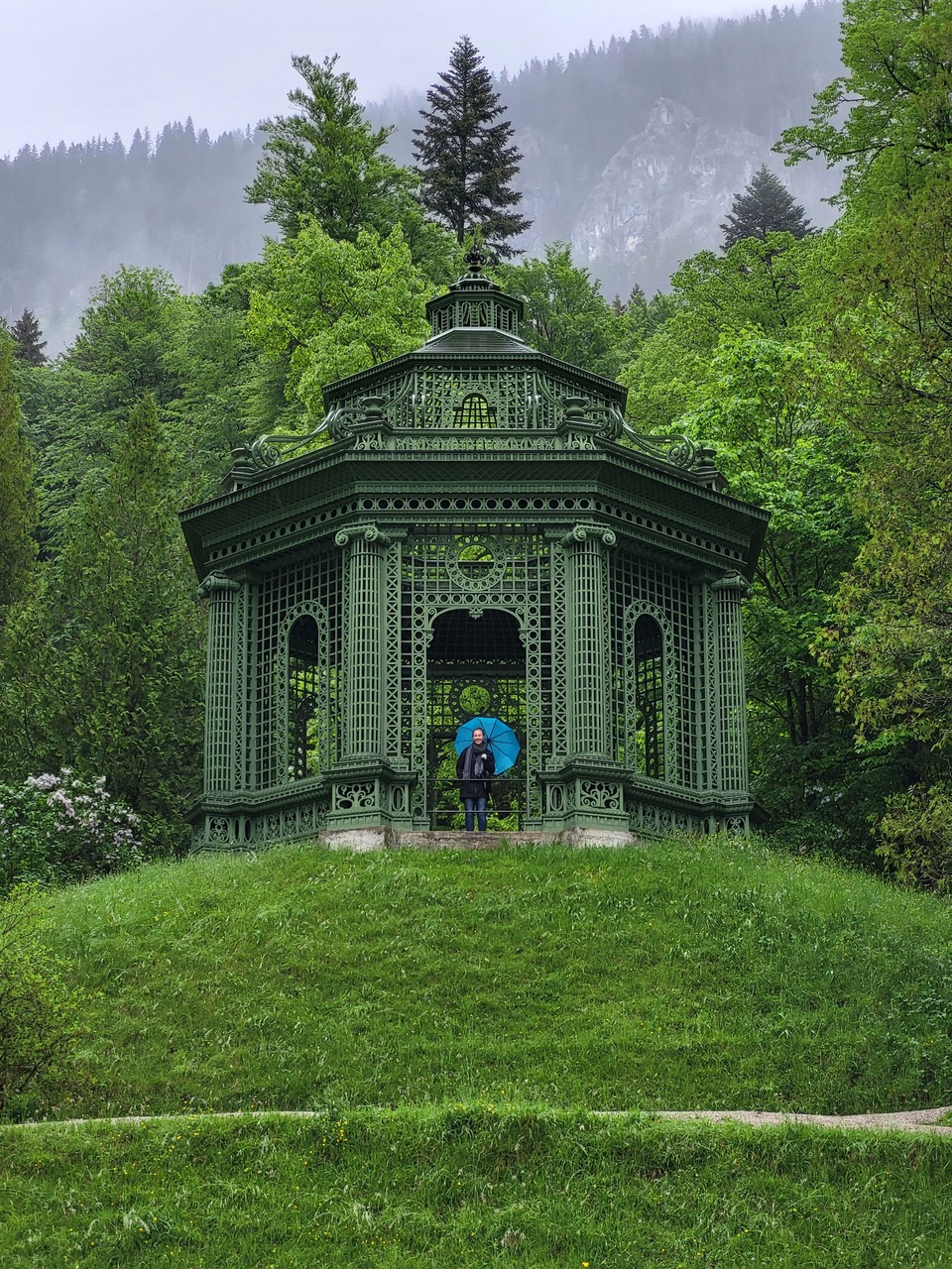 Maddie in the Linderhof palace gardens with blue umbrella