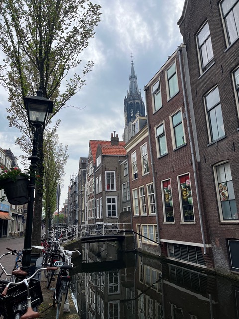 bridge over narrow Delft canal with the tower of the new church in the background