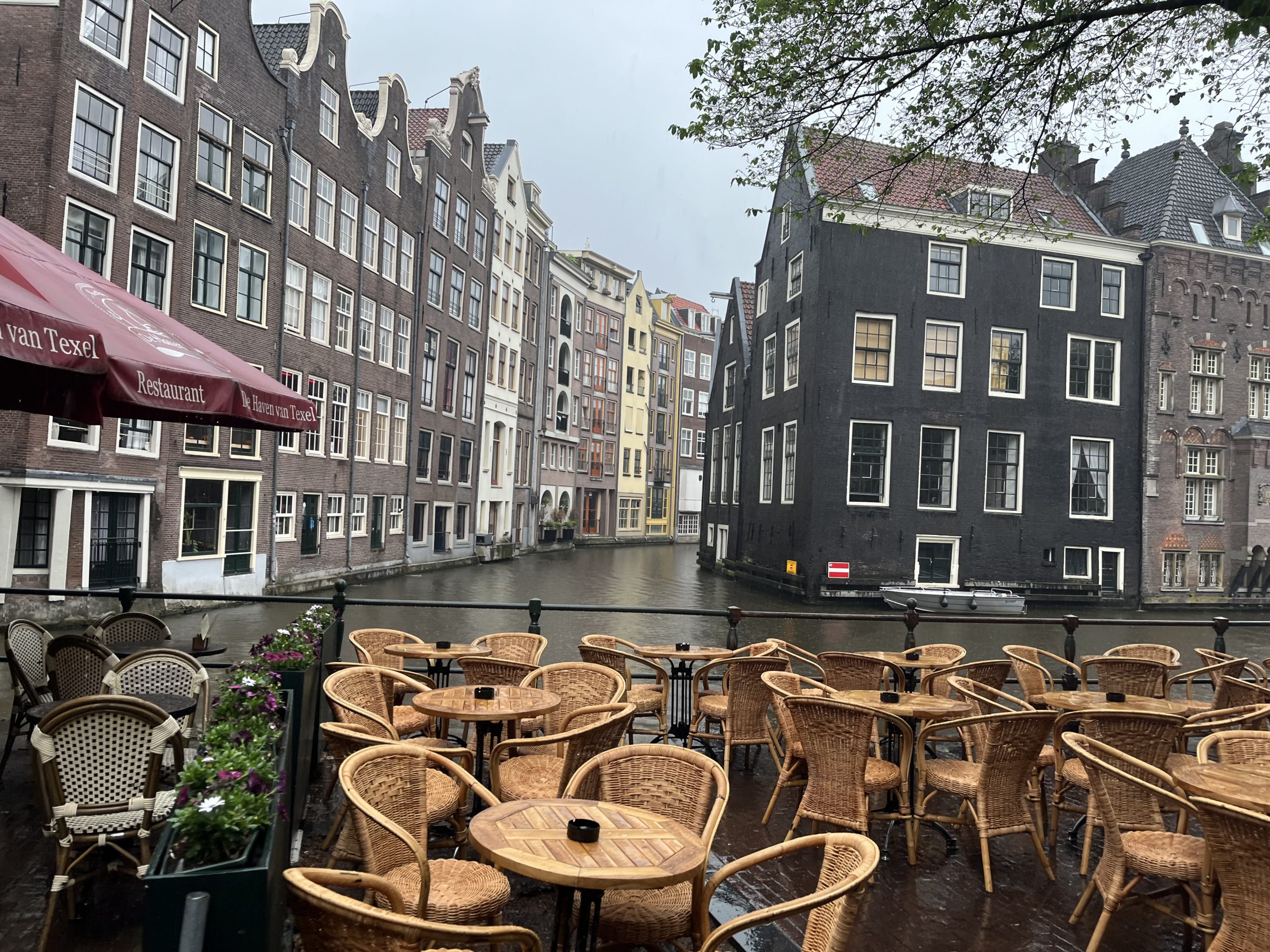 Amsterdam canal with wicker chairs