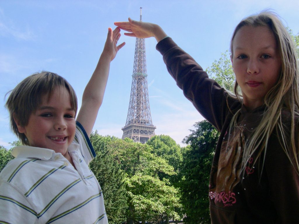 Young Maddie and brother in front of the Eiffel Tower