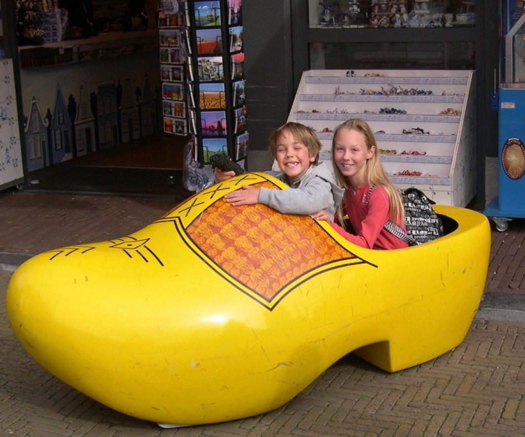 Young Maddie and brother in a large yellow Dutch clog