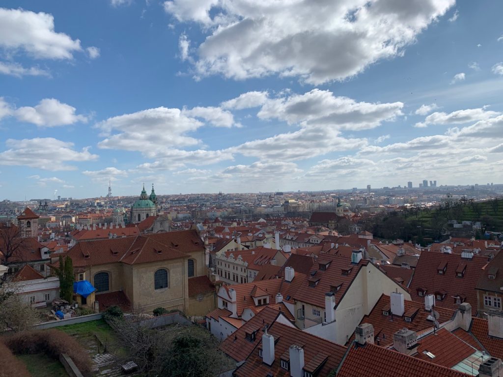 View of Prague from above with red roofs and spires