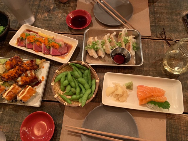 assorted sushi, edamame, and dumplings