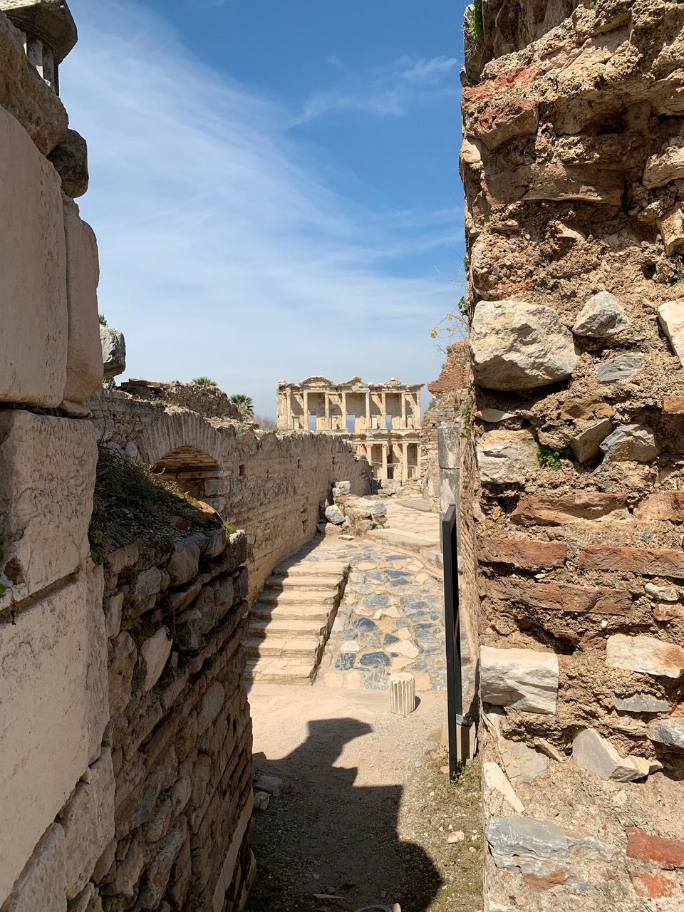 narrow alley between crumbling Roman structures