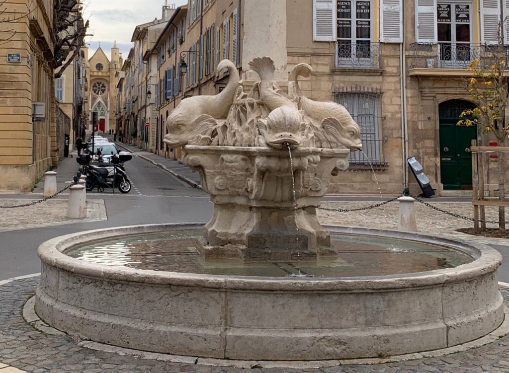 A fountain of four dolphins spitting water into a basin