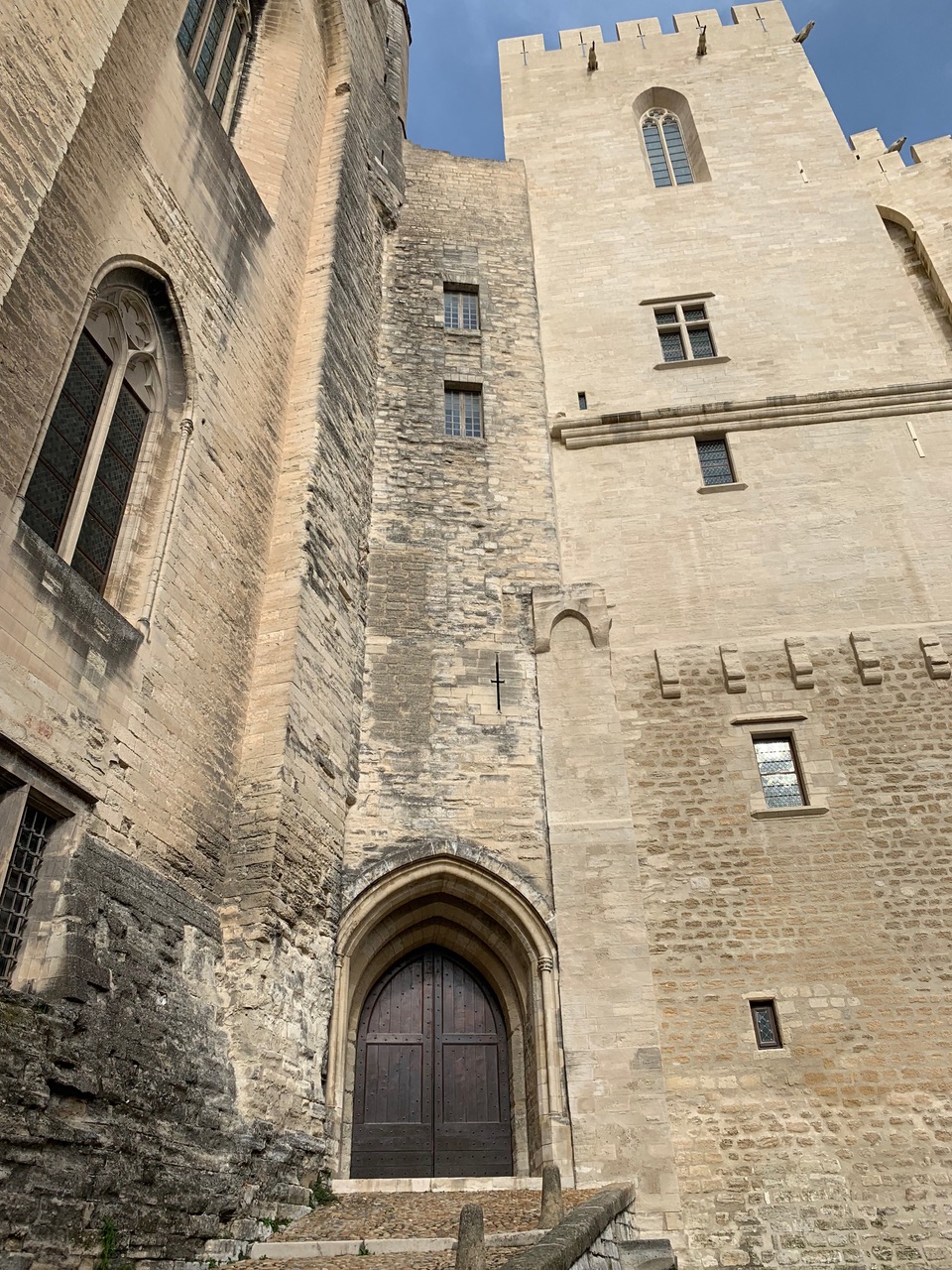 a narrow door in the corner of two imposing walls