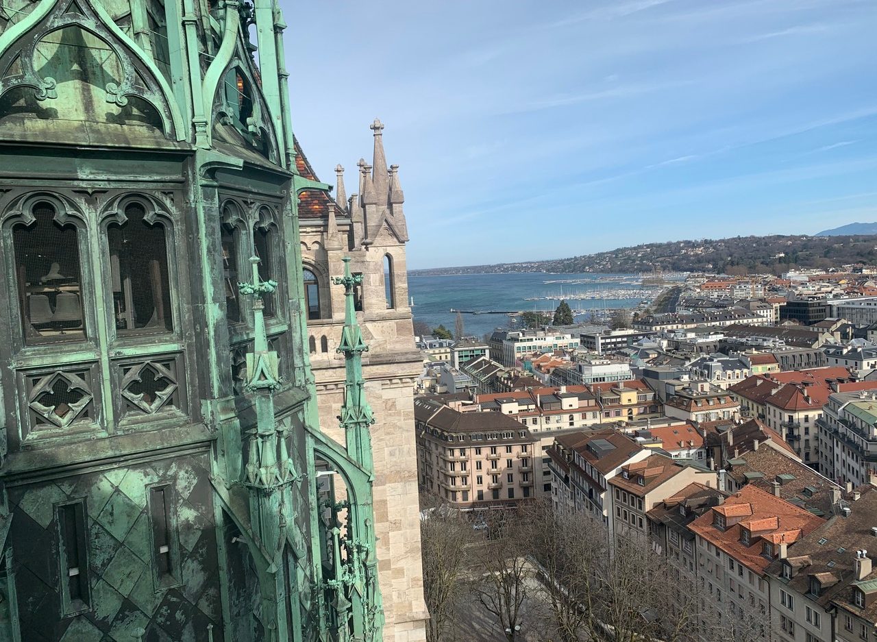 View of Lake Geneva past the second tower of the Cathedral Saint Pierre