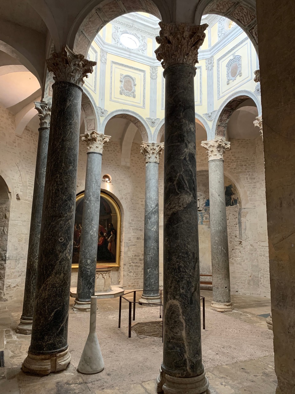Eight marble columns surrounding an octagonal baptismal pool
