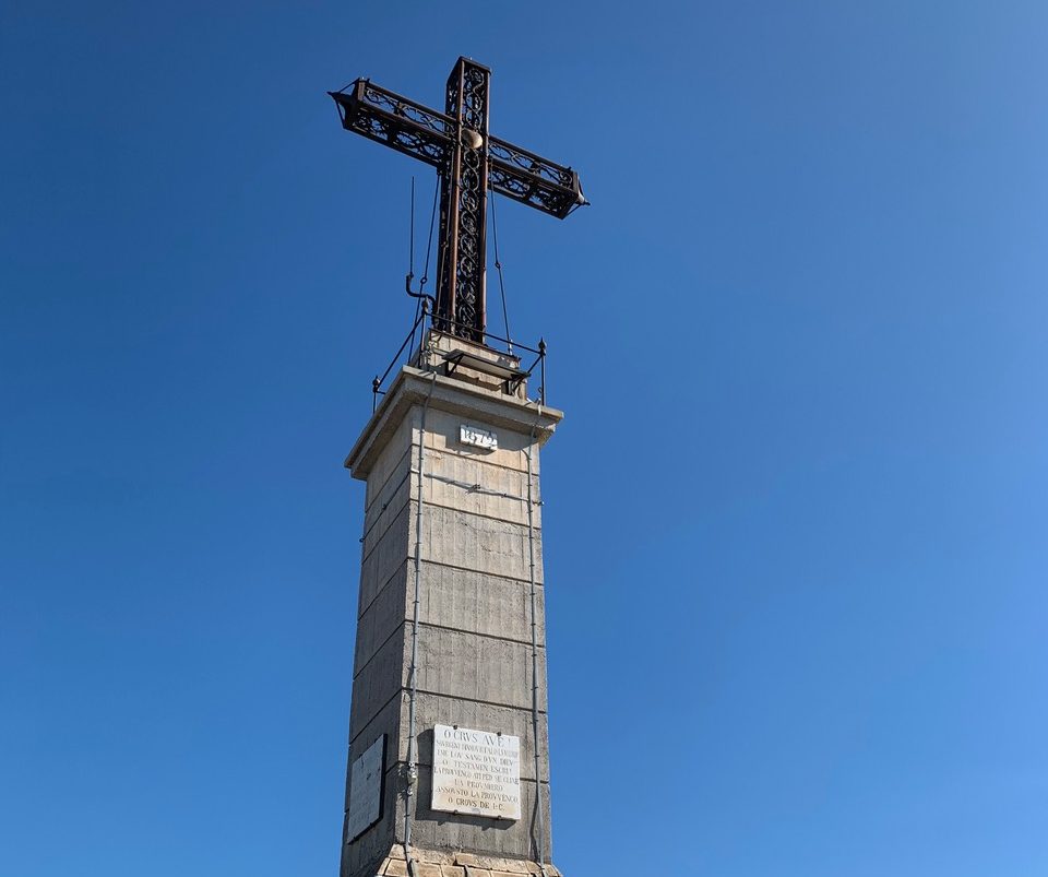 Large metal cross in a deep blue sky