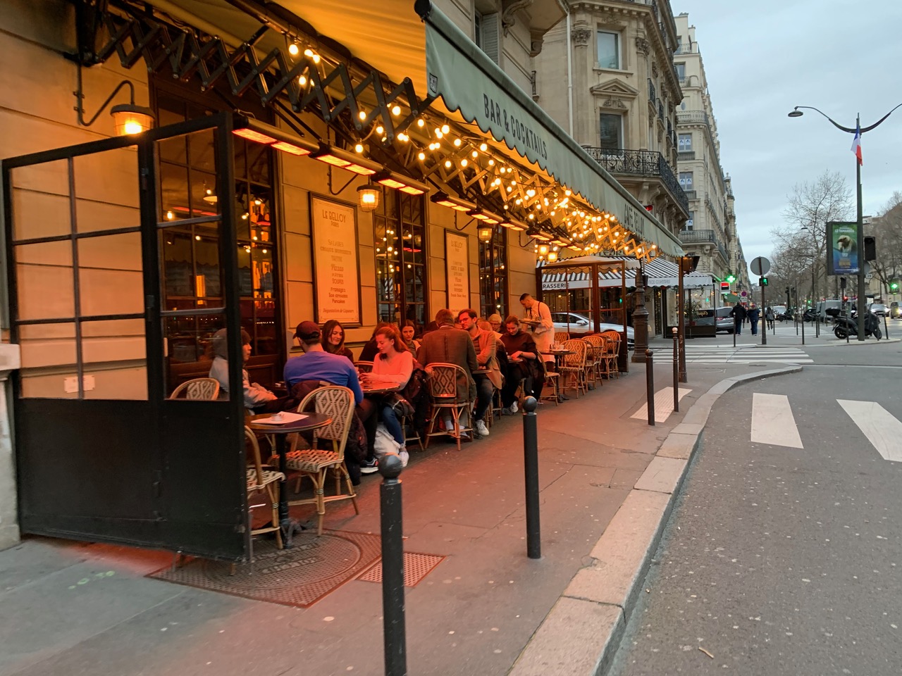 Paris cafe with lights and wicker tables