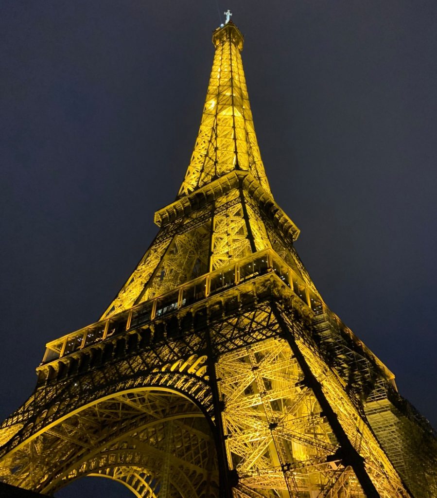 Ants-eye view of the glowing Eiffel tower at night