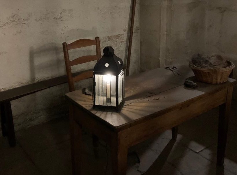 wood table with a lamp, shears, and basket