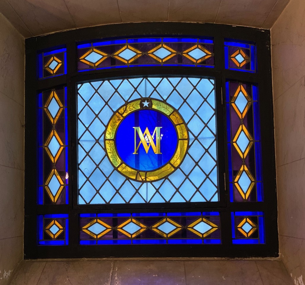 Stained glass window with Marie Antoinette's symbol