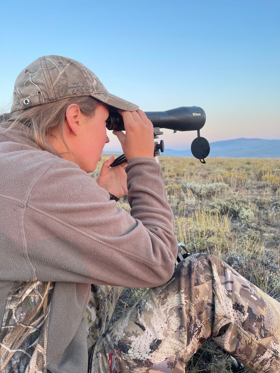 Maddie looking through a scope in 201 Colorado