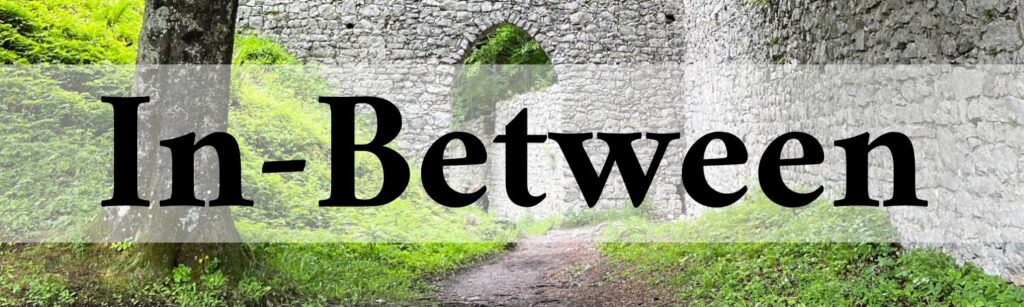 white brick castle wall with pointed archway overgrow with greenery overlaid with word in-between